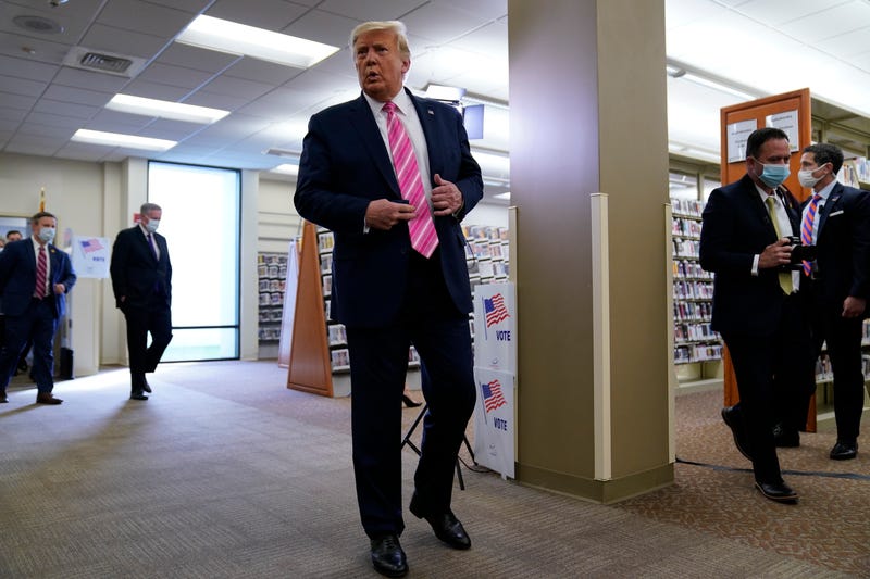 President Donald Trump talks with reporters after casting his ballot in the presidential election, Saturday, Oct. 24, 2020, in West Palm Beach, Fla.