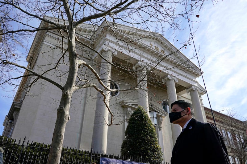 A member of the U.S. Secret Service stands guard outside Holy Trinity Catholic Church as President Joe Biden attends mass, Sunday, Jan. 24, 2021, in the Georgetown neighborhood of Washington.