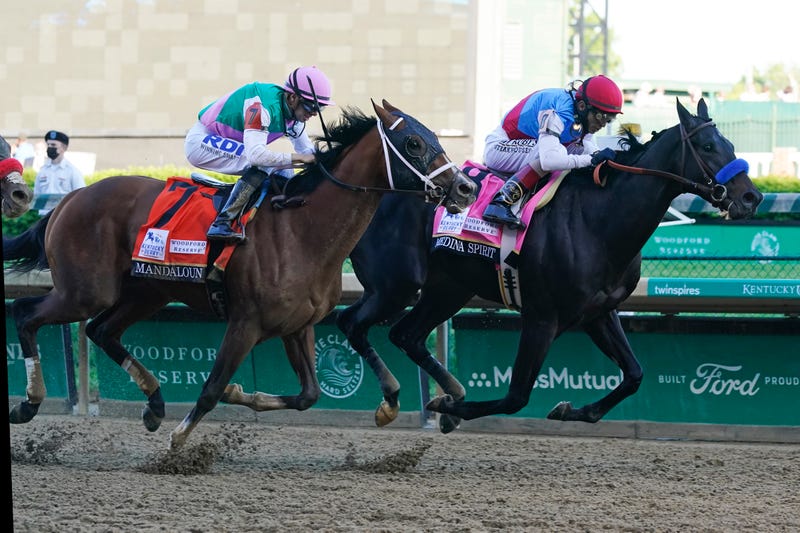 John Velazquez, right, rides Medina Spirit ahead of Florent Geroux aboard Mandaloun to win the 147th running of the Kentucky Derby at Churchill Downs, Saturday, May 1, 2021, in Louisville, Ky