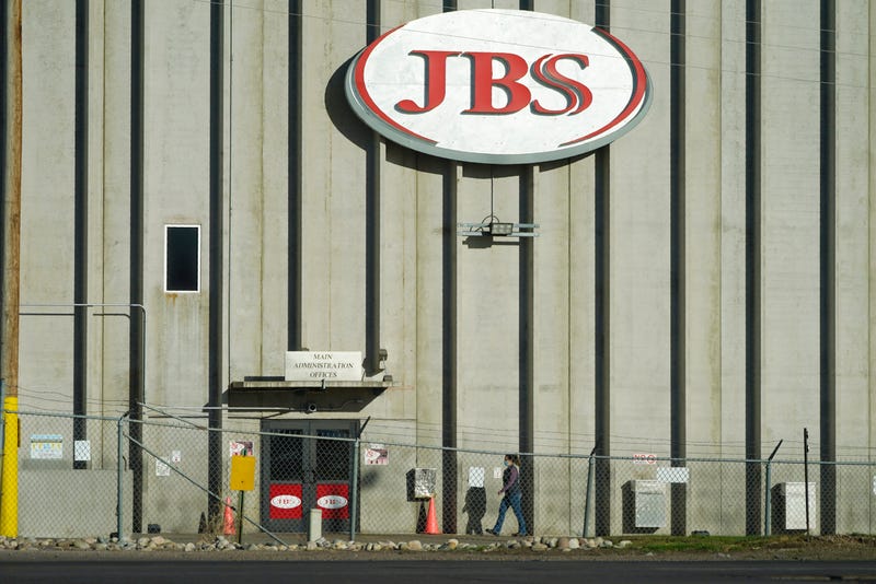 A worker heads into the JBS meatpacking plant in Greeley, Colo.