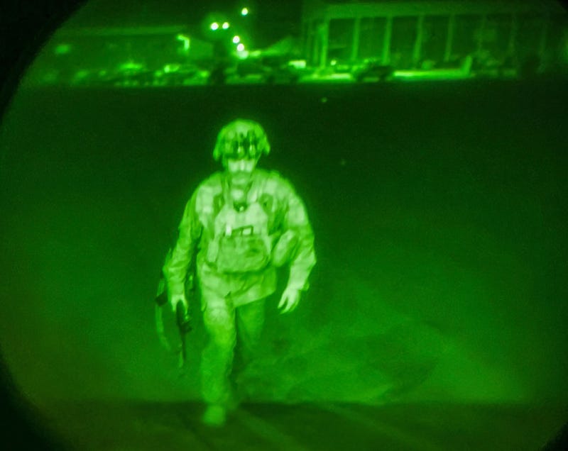 In this image made through a night vision scope and provided by U.S. Central Command, Maj. Gen. Chris Donahue, commander of the U.S. Army 82nd Airborne Division, XVIII Airborne Corps, boards a C-17 cargo plane at the Hamid Karzai International Airport in Kabul, Afghanistan, Monday, Aug. 30, 2021, as the final American service member to depart Afghanistan.