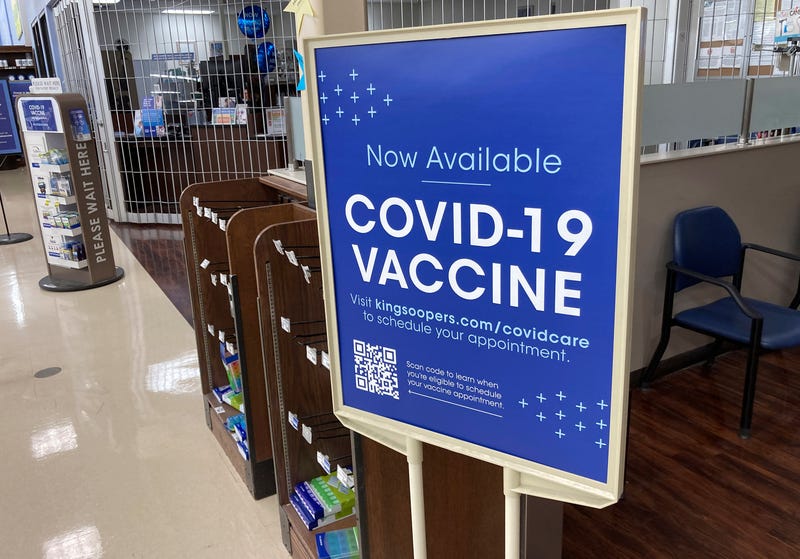 Sign notifies customers that COVID-19 vaccinations are available at a pharmacy