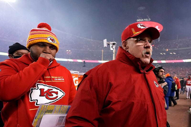 Kansas City Chiefs head coach Andy Reid, right, walks off the field.
