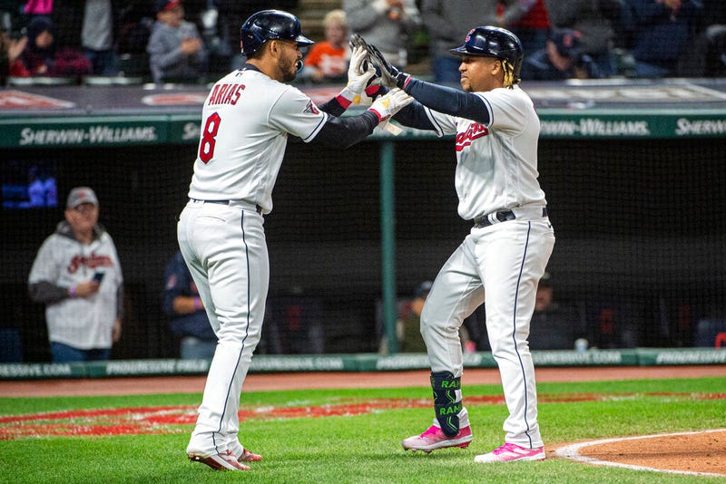 Cleveland Guardians' Gabriel Arias (8) congratulates Jose Ramirez, who hit a three-run home run off Kansas City Royals starting pitcher Brady Singer