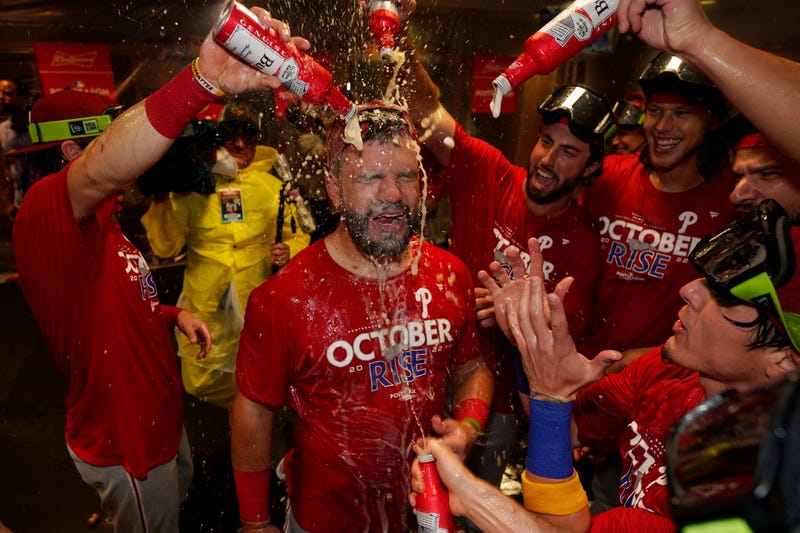 Philadelphia Phillies' Kyle Schwarber, center, celebrates with teammates after the Phillies won a baseball game against the Houston Astros to clinch a wild-card playoff spot, Monday, Oct. 3, 2022, in Houston.