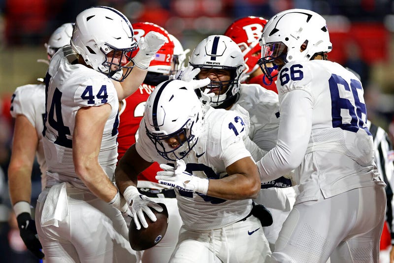 Penn State running back Kaytron Allen (13) is congratulated by teammates after scoring a touchdown against Rutgers during the second half of an NCAA college football game, Saturday, Nov. 19, 2022, in Piscataway, N.J. Penn State won 55-10.