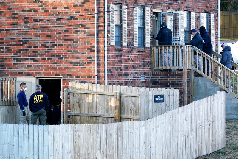 FBI and ATF agents investigate a home Saturday, Dec. 26, 2020, in Nashville, Tenn. An explosion that shook the largely deserted streets of downtown Nashville early Christmas morning shattered windows, damaged buildings, and wounded three people. Authorities said they believed the blast was intentional.