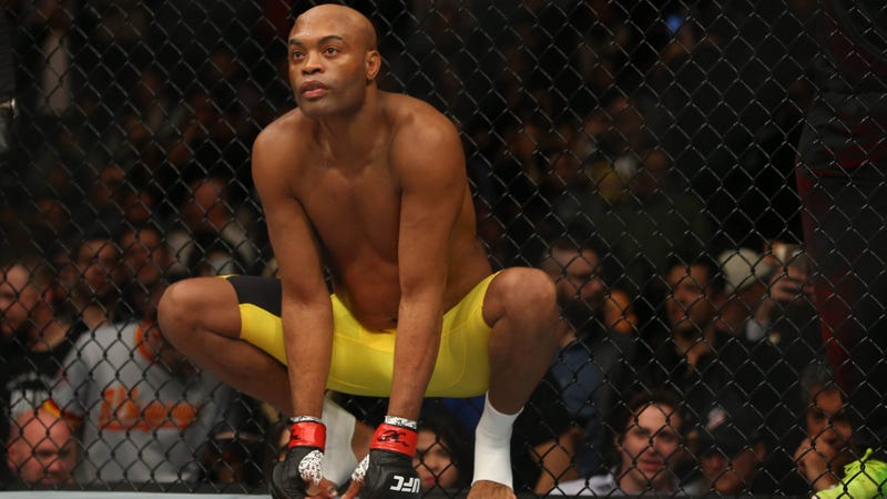 Anderson Silva crouches in cage