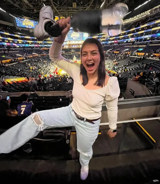 Annika Nadine Hutsler holding up her prosthetic leg at Crypto Arena Tuesday night