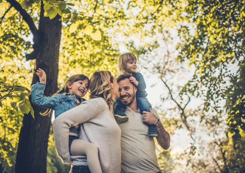 Below view of carefree family having fun in spring day