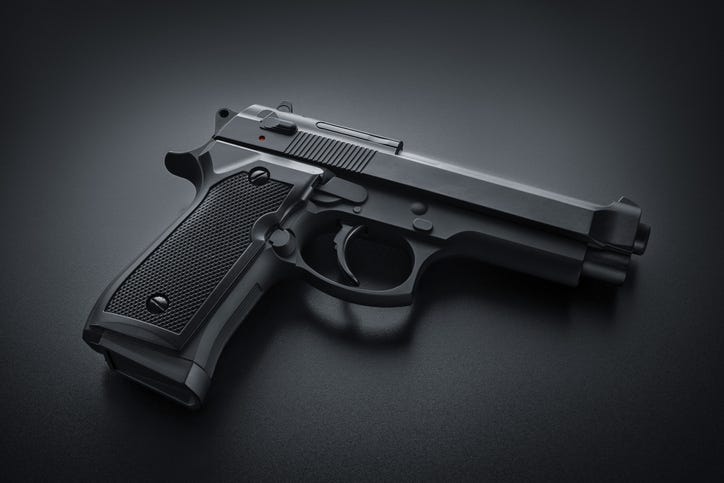 Black handgun on black background