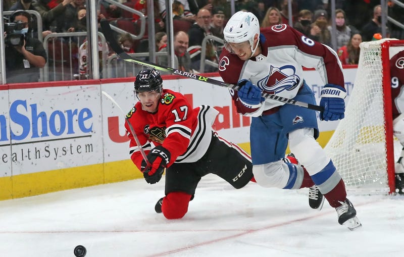 Blackhawks center Dylan Strome (17) and Avalanche defenseman Erik Johnson (6) chase the puck.
