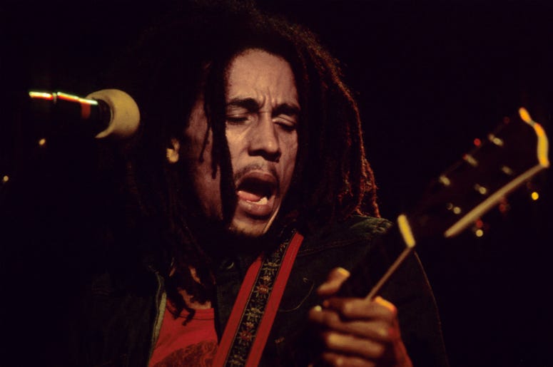 Bob Marley plays his guitar on stage during a gig at the Hammersmith Odeon, London