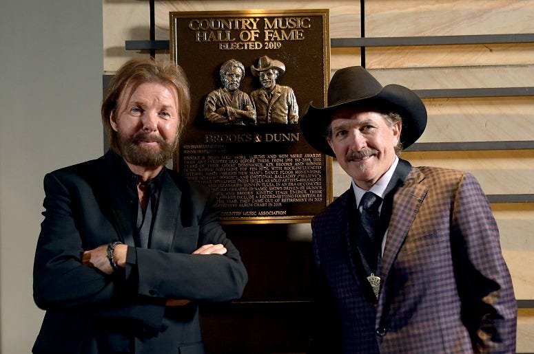 Inductee Ronnie Dunn and Kix Brooks of Brooks & Dunn seen with their Hall of Fame plaque