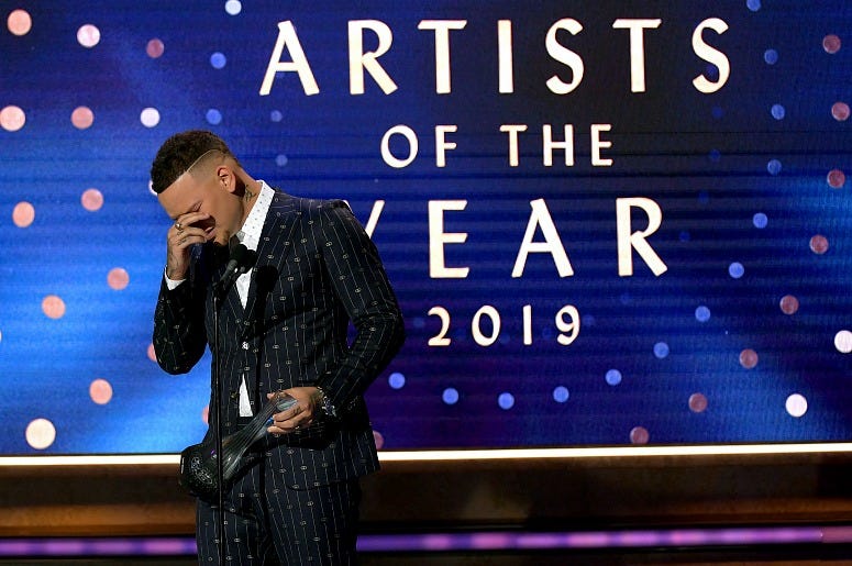 Kane Brown accepts an award onstage during the 2019 CMT Artists of the Year