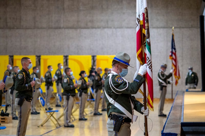 CHP graduates stand for the flag.