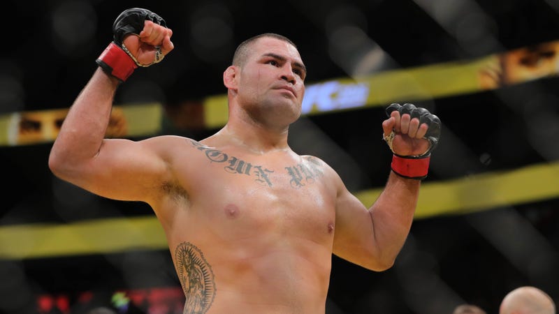 Cain Velasquez poses in the cage after UFC win over Travis Browne