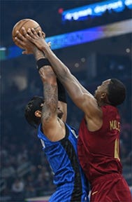 Cleveland Cavaliers center Evan Mobley (4) blocks the shot of Orlando Magic forward Paolo Banchero (5) during the first quarter at Rocket Mortgage FieldHouse.