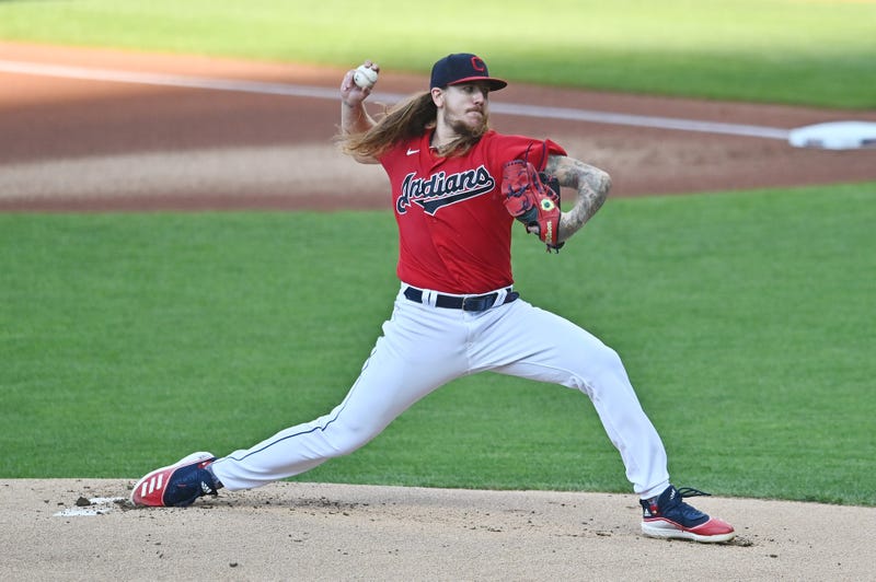 Caption: Aug 5, 2020; Cleveland, Ohio, USA; Cleveland Indians starting pitcher Mike Clevinger (52) throws a pitch during the first inning against the Cincinnati Reds at Progressive Field.