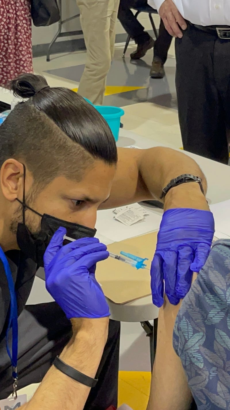 A woman receives her coronavirus vaccination