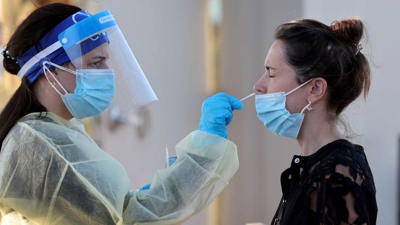 Jordane Domain gets a COVID-19 test done by a healthcare worker on January 13, 2022 in North Miami, Florida.