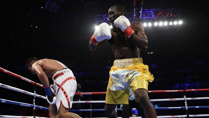 Terence Crawford hits Amir Khan with an accidental low blow during their welterweight boxing match at Madison Square Garden.