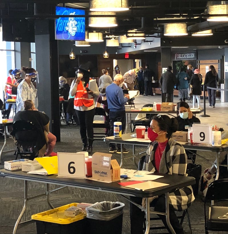 Vaccinators await customers at a vaccine clinic, Dunkin' Donuts Park, Hartford, 2/27/21.