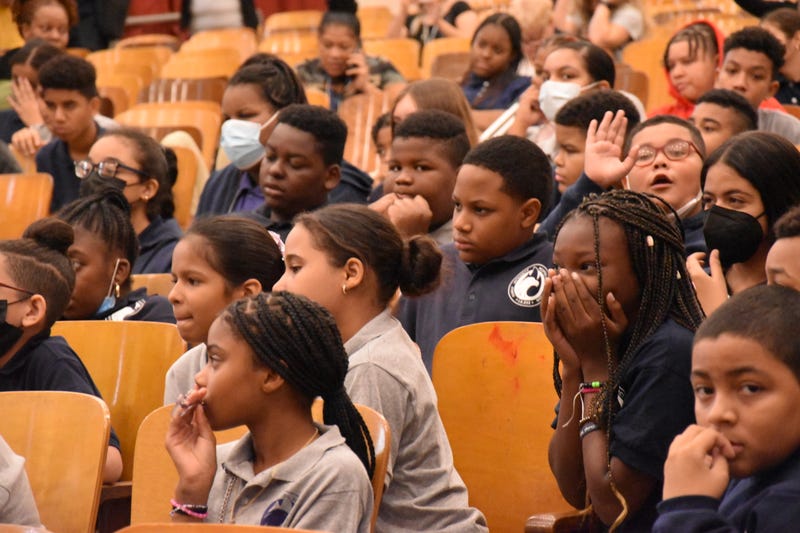 Students watching Cardi B deliver speech at their middle school