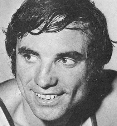 Dave DeBusschere smiles in an up-close headshot.
