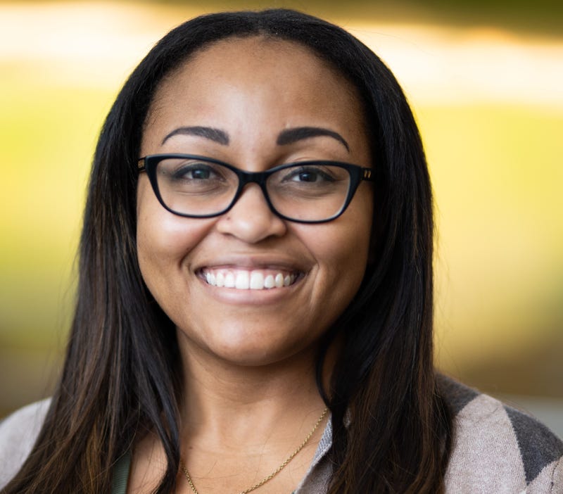 dr. kanika cunningham headshot. she is a black woman with long dark straight hair, black glasses