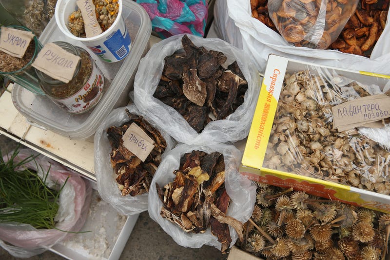 A vendor sells dried mushrooms