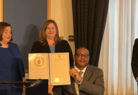 Pittsburgh Mayor Ed Gainey holds up executive order