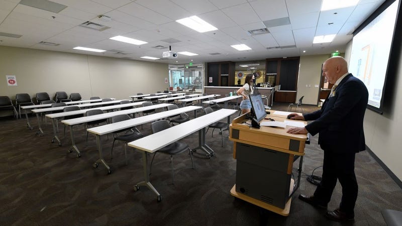 Hospitality College professor Dr. Murray Mackenzie (R) gets ready to teach a remote Spirits and Liqueurs of the World course as his senior student and assistant Delaney Snyder looks on at UNLV amid the spread of the coronavirus (COVID-19) on August 31, 2020 in Las Vegas, Nevada