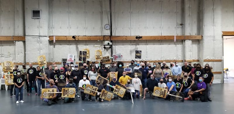 IATSE members pose for a photo as their union prepared to strike before reaching a labor deal with film and television producers.
