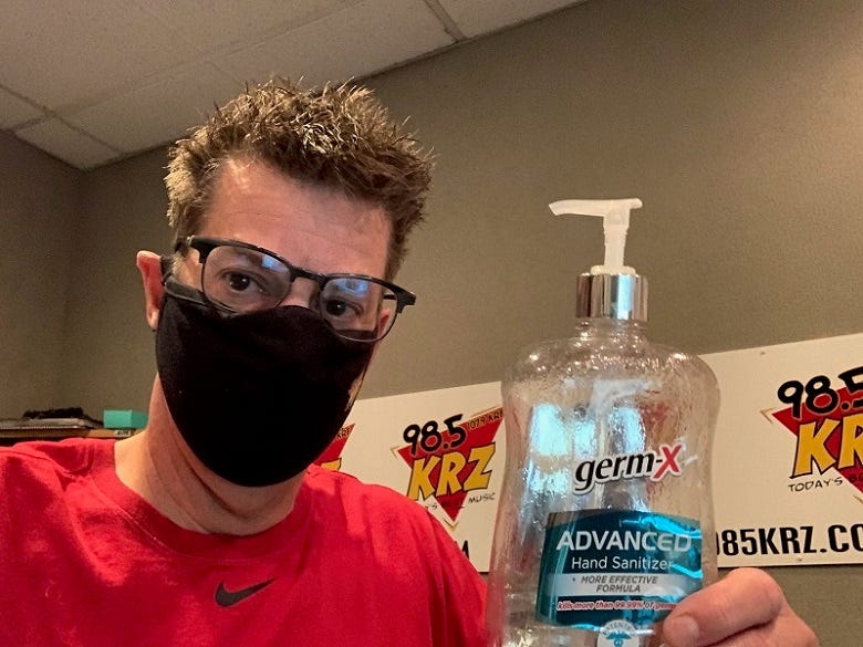 Rock wearing surgical mask & holding hand sanitizer