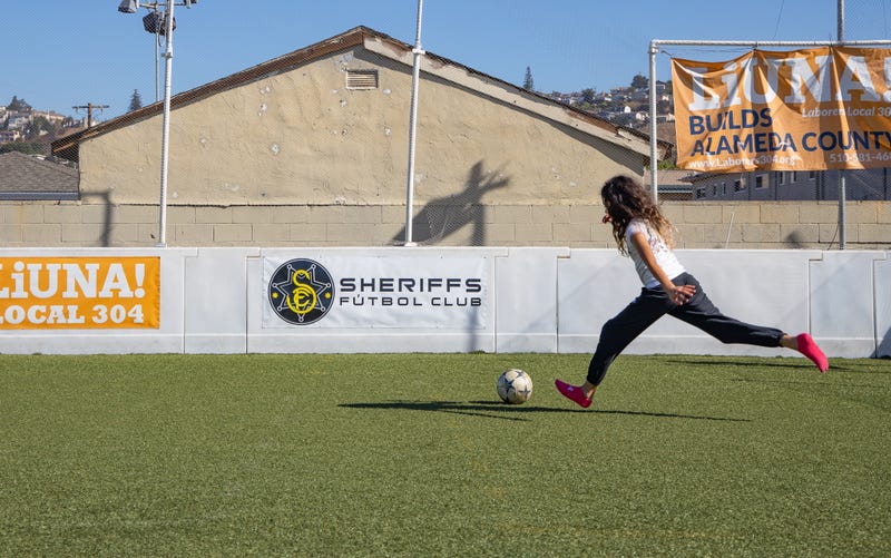 Fourth grader Erikka Flores kicks a soccer ball.