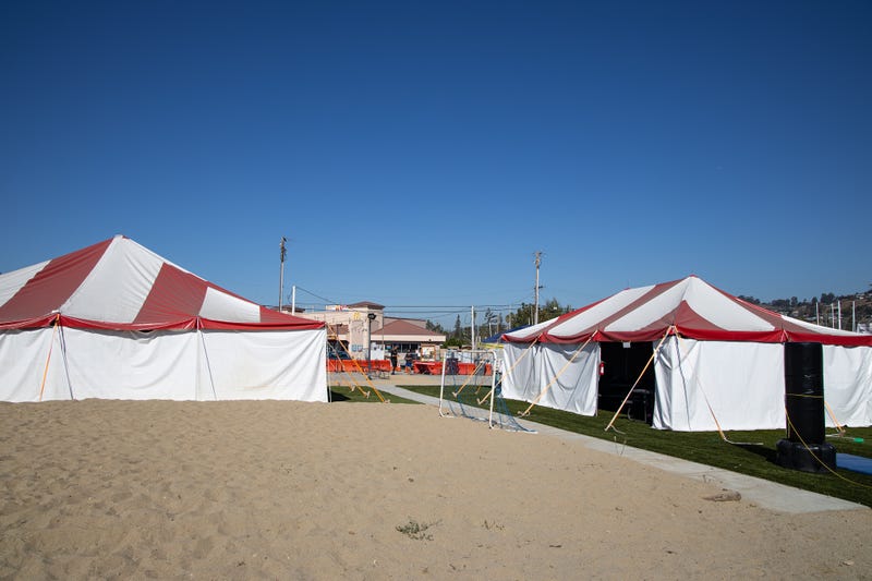 A pop-up education hub hosted by the Alameda County Sheriff's Department under red and white tents in San Leandro.