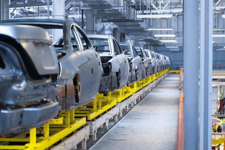 cars being assembled in factory