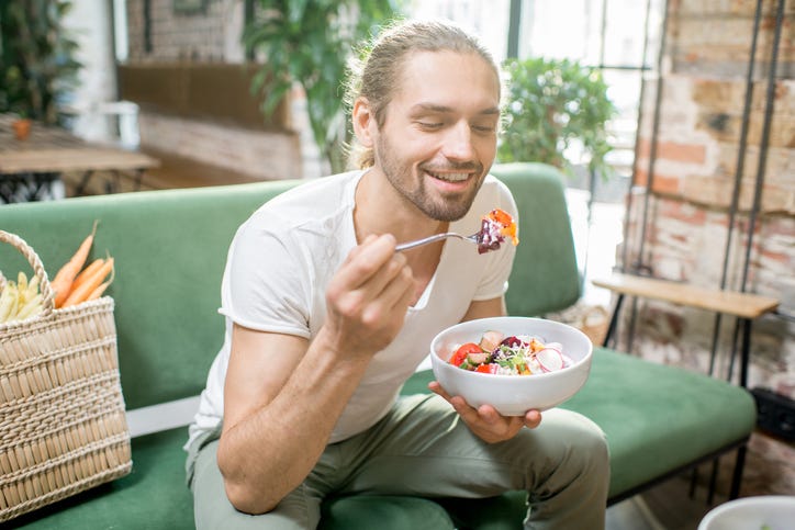 man eats vegetables