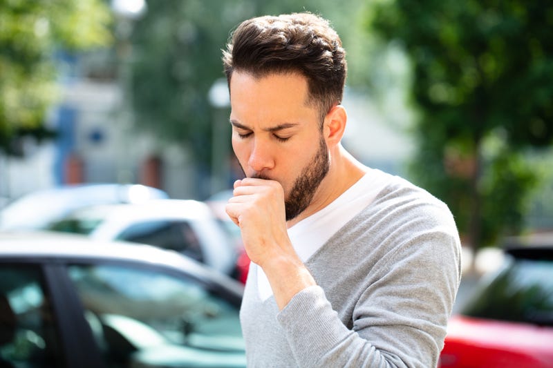 man coughing