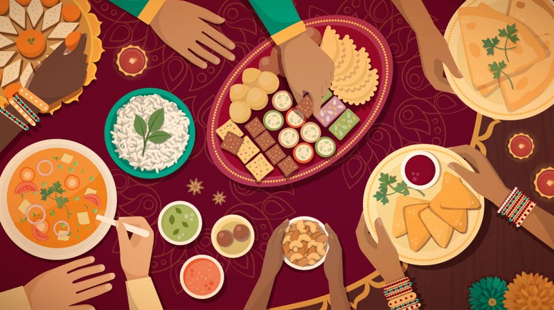 Family celebrating Diwali at home with lamps and traditional food, top view
