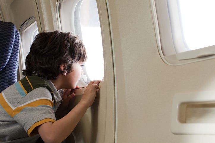 Boy riding airplane