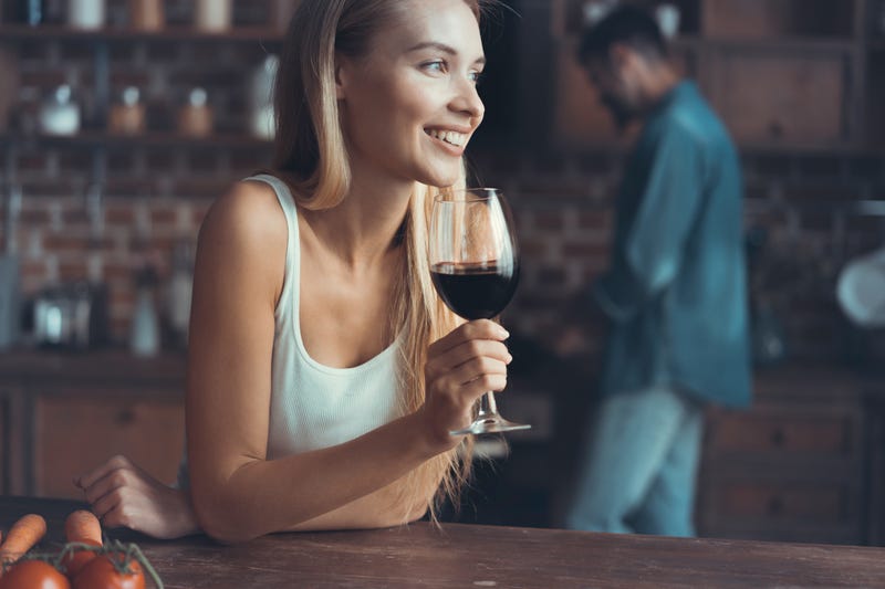woman enjoying glass of wine at the bar