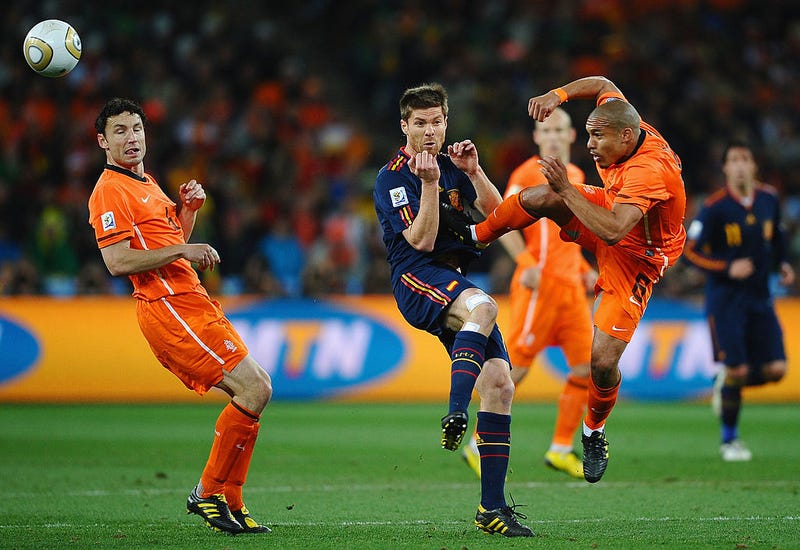 Nigel De Jong of the Netherlands tackles Xabi Alonso of Spain with a kick in the chest during the 2010 FIFA World Cup South Africa Final match between Netherlands and Spain at Soccer City Stadium on July 11, 2010 in Johannesburg, South Africa.