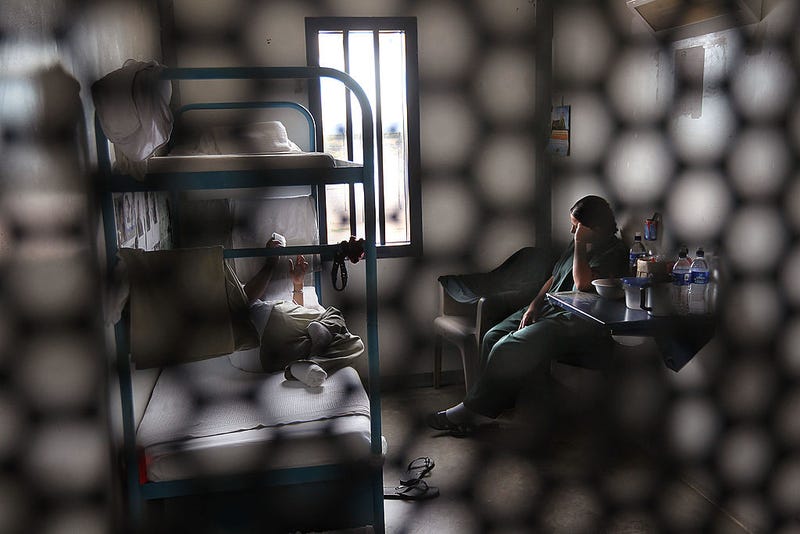 Immigrants sit in their housing cell in the women's wing of the detention facility