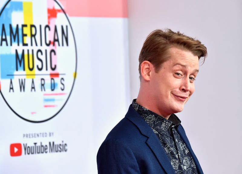 macaulay culkin with a cheeky smirk on the runway at the american music awards