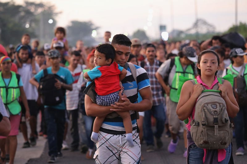 Members of a migrant caravan walk into the interior of Mexico after crossing the Guatemalan border