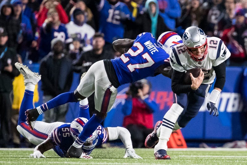 patriots quarterback tom brady is brought down by tre-davious white of the buffalo bills