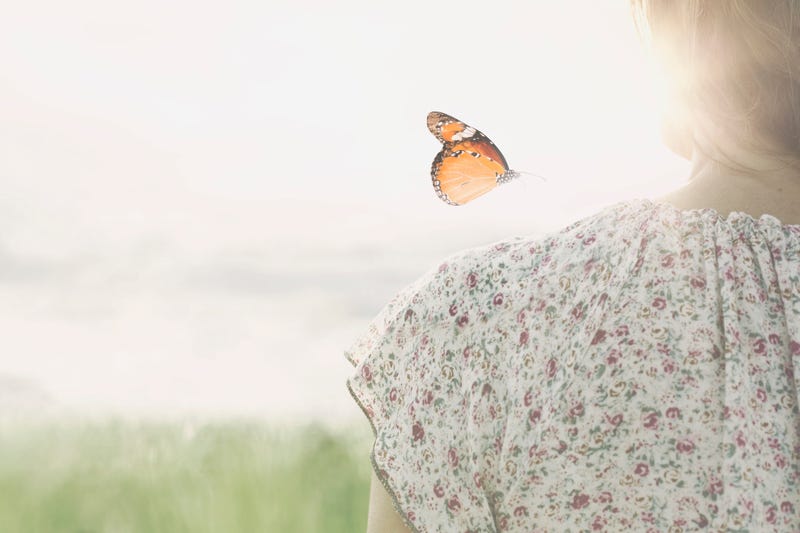 Butterfly over girl's shoulder