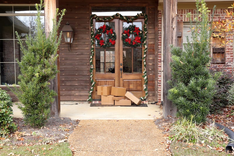 Boxes and packages next to front door during holiday Christmas season.